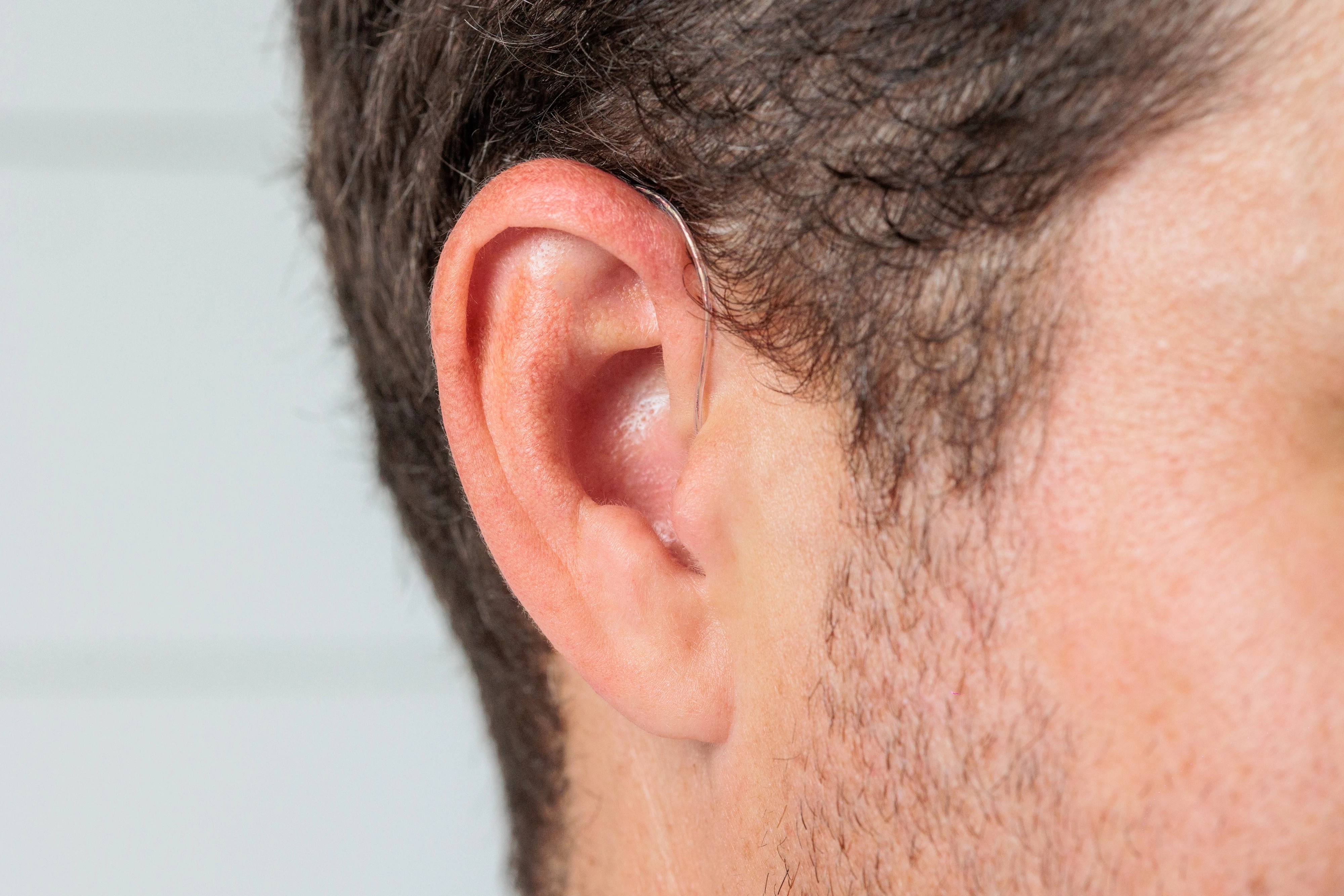 starkey omega ai mric in chestnut closeup on ear